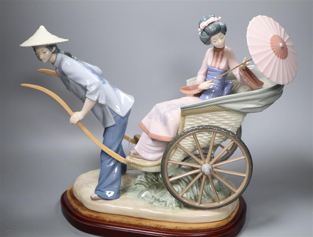 A large Lladro of a Japanese rickshaw, on plinth, height 33cm